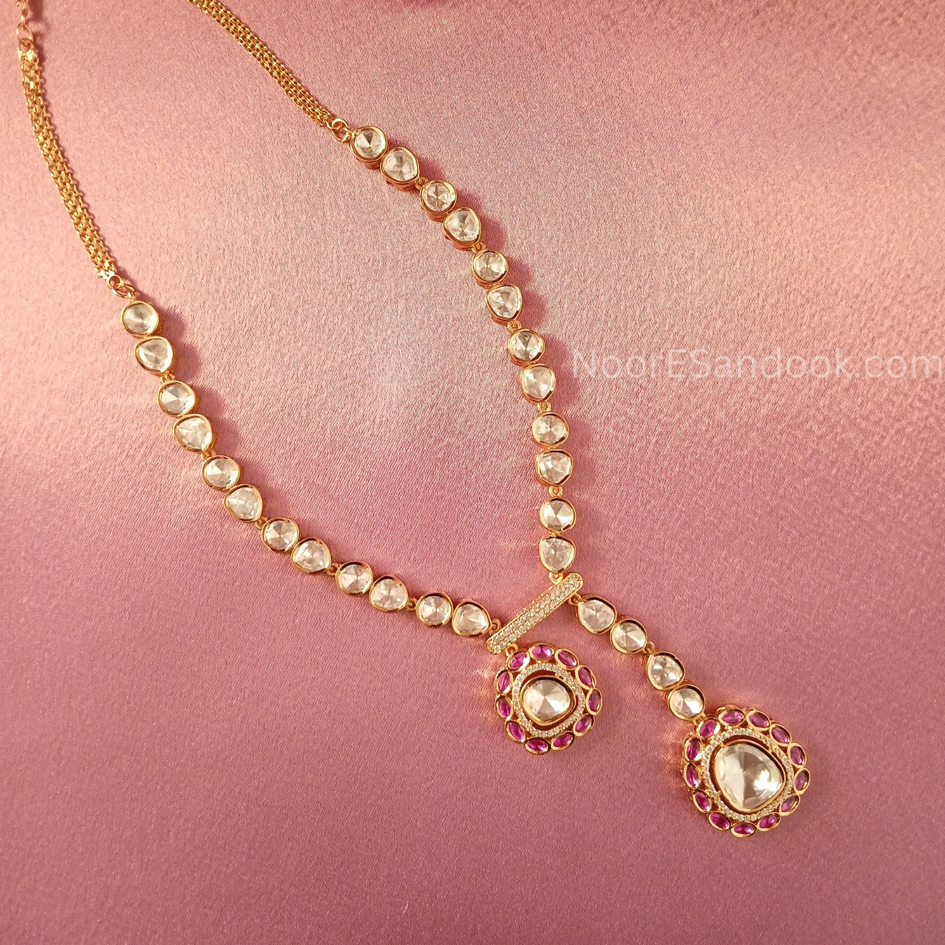 One small and one big pendant in long necklace